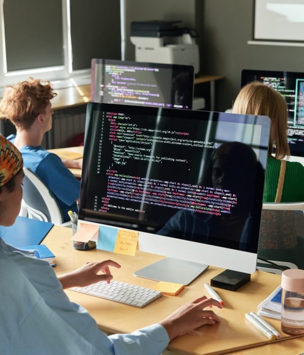 Group of students writing computer codes during lesson at school